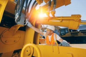 construction worker fixing construction equipment