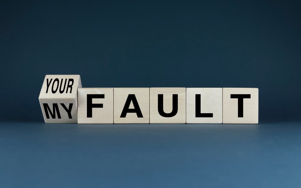 letter blocks spelling out 'your fault' and 'my fault'