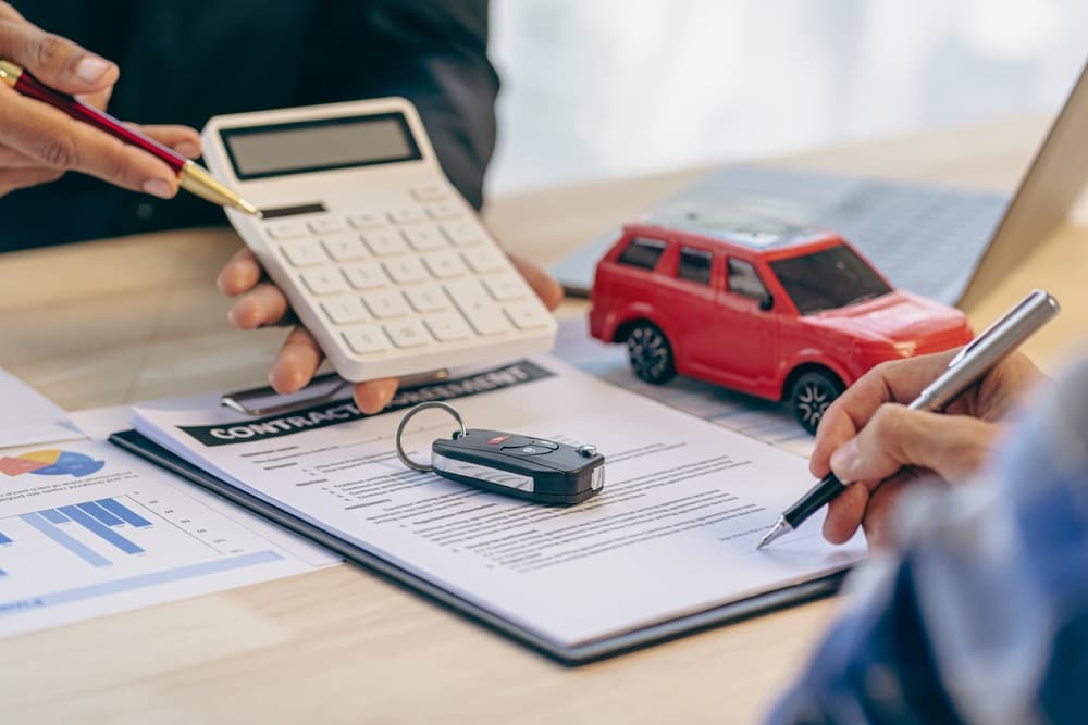 Car dealerships and customers sign car insurance documents or rental paper.