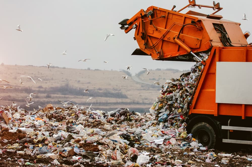 A garbage truck unloading waste at a landfill.







