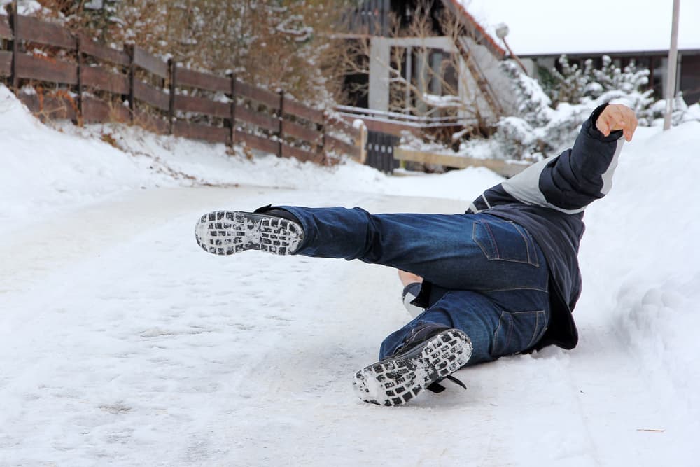 Winter hazard: A man slips and falls on icy ground.